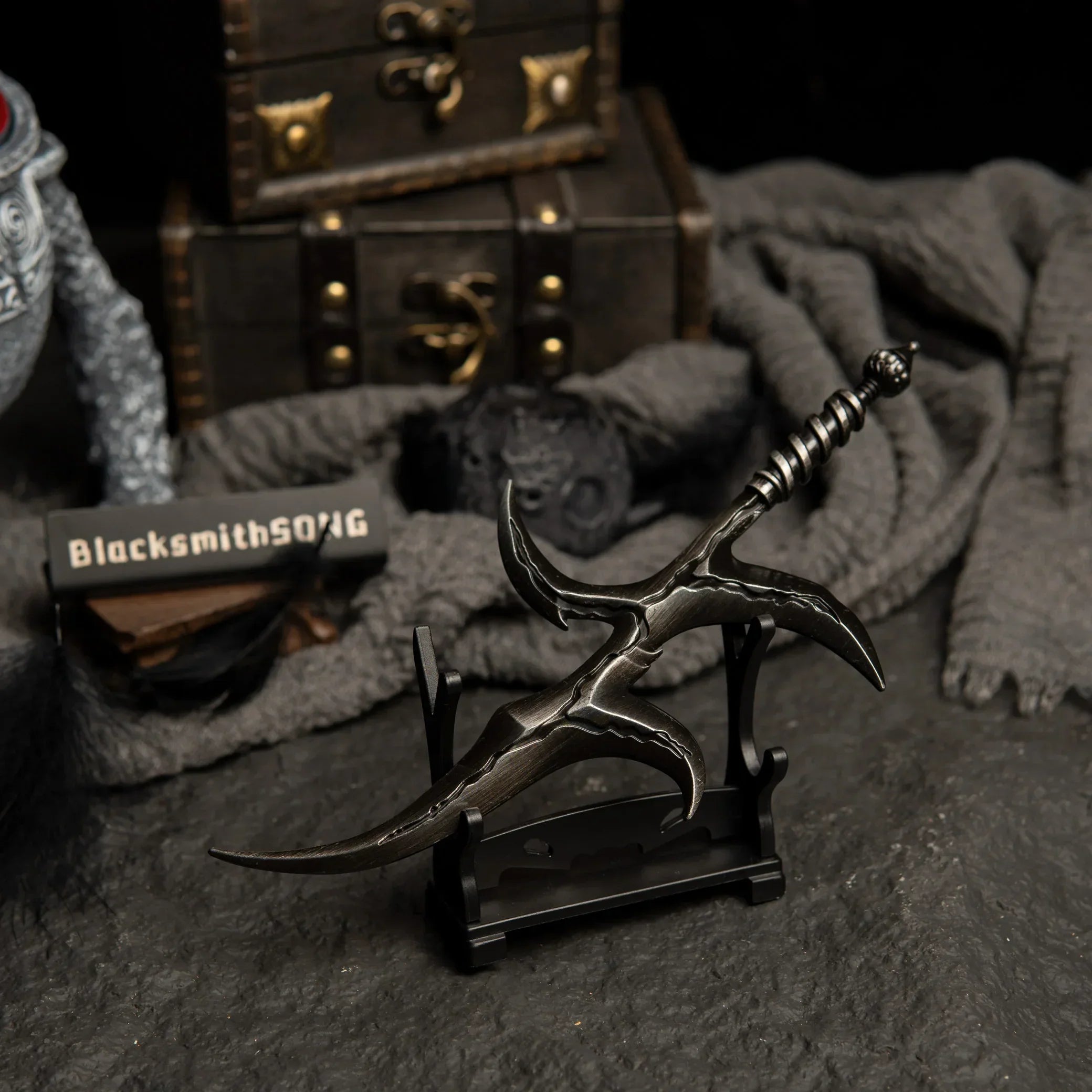 Black Knife metal dagger displayed on a small horizontal stand.