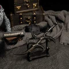 Black Knife metal dagger displayed on a small horizontal stand.