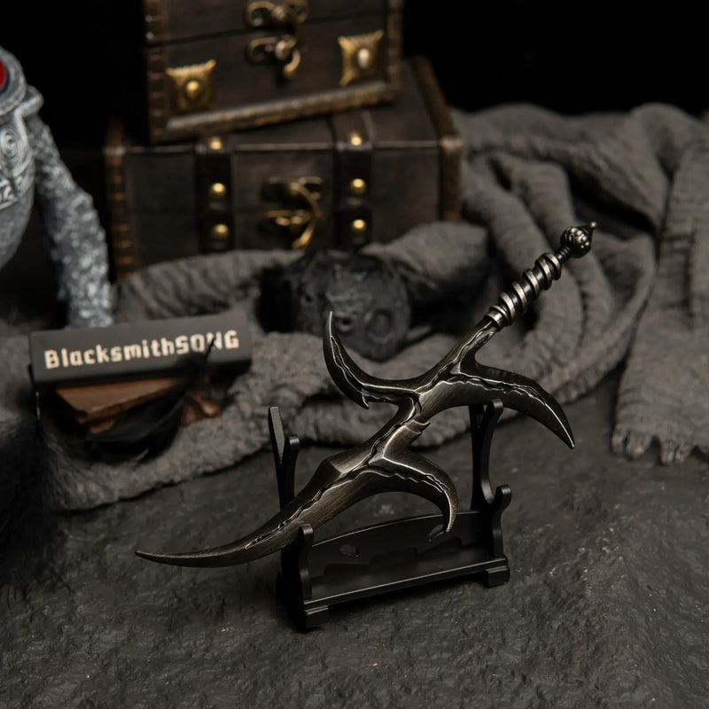 Black Knife metal dagger displayed on a small horizontal stand.