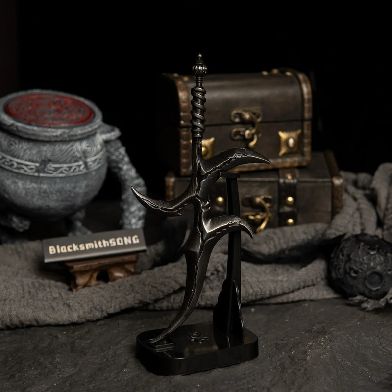 Vertical display of the Black Knife replica on an upright black stand against a dark background.