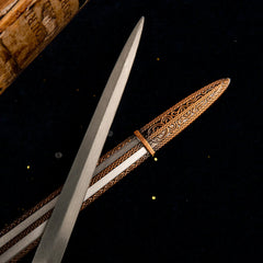 Macro shot of the scabbard details on the Carian Knight's Sword replica, showing intricate filigree patterns.