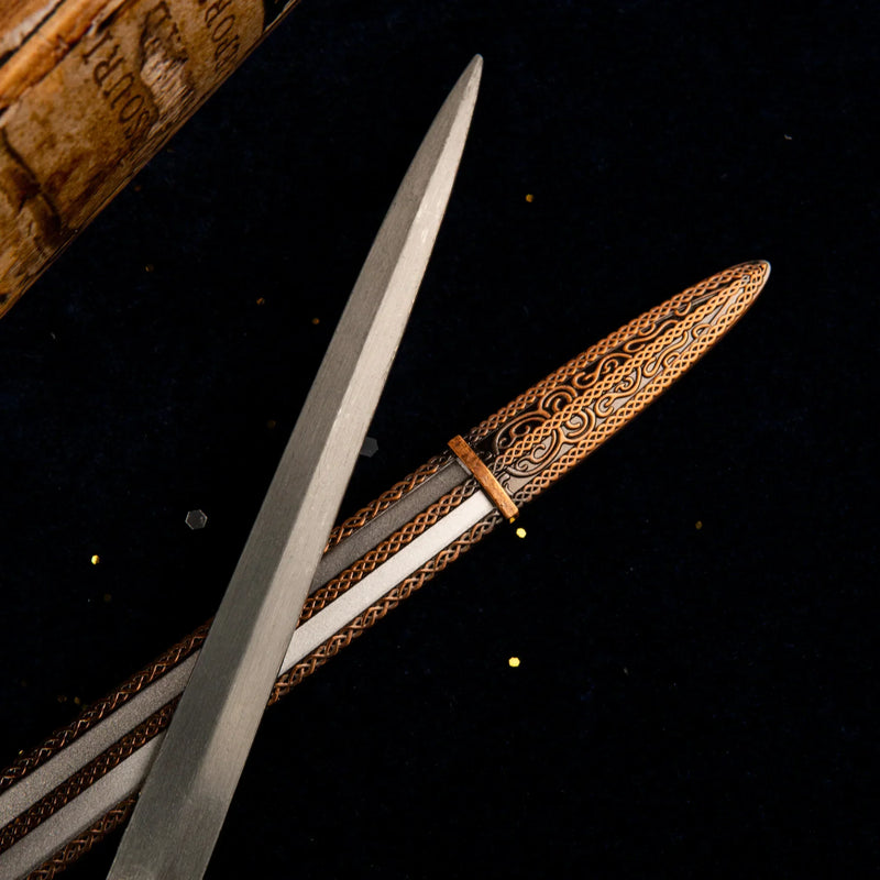 Macro shot of the scabbard details on the Carian Knight's Sword replica, showing intricate filigree patterns.