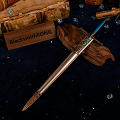Top-down view of the Carian Knight's Sword and scabbard on a blue velvet background with map scrolls.