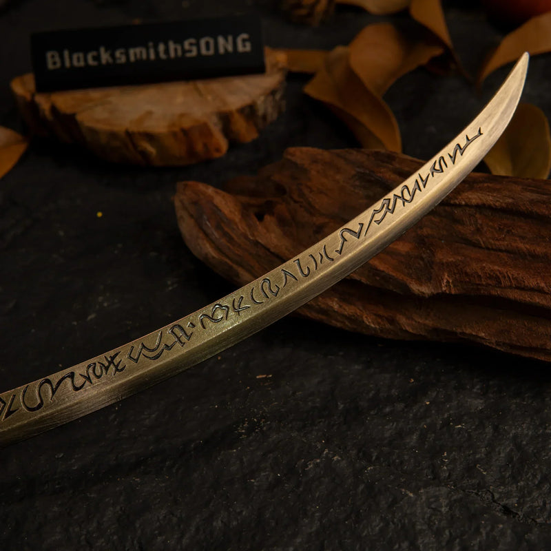 Macro shot of the intricate runic engravings along the gold blade of the Hand of Malenia replica.