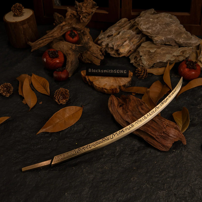 Hand of Malenia replica resting on dark wood surrounded by dry autumn leaves and pinecones.
