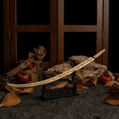 Hand of Malenia katana displayed horizontally on a large black sword stand.