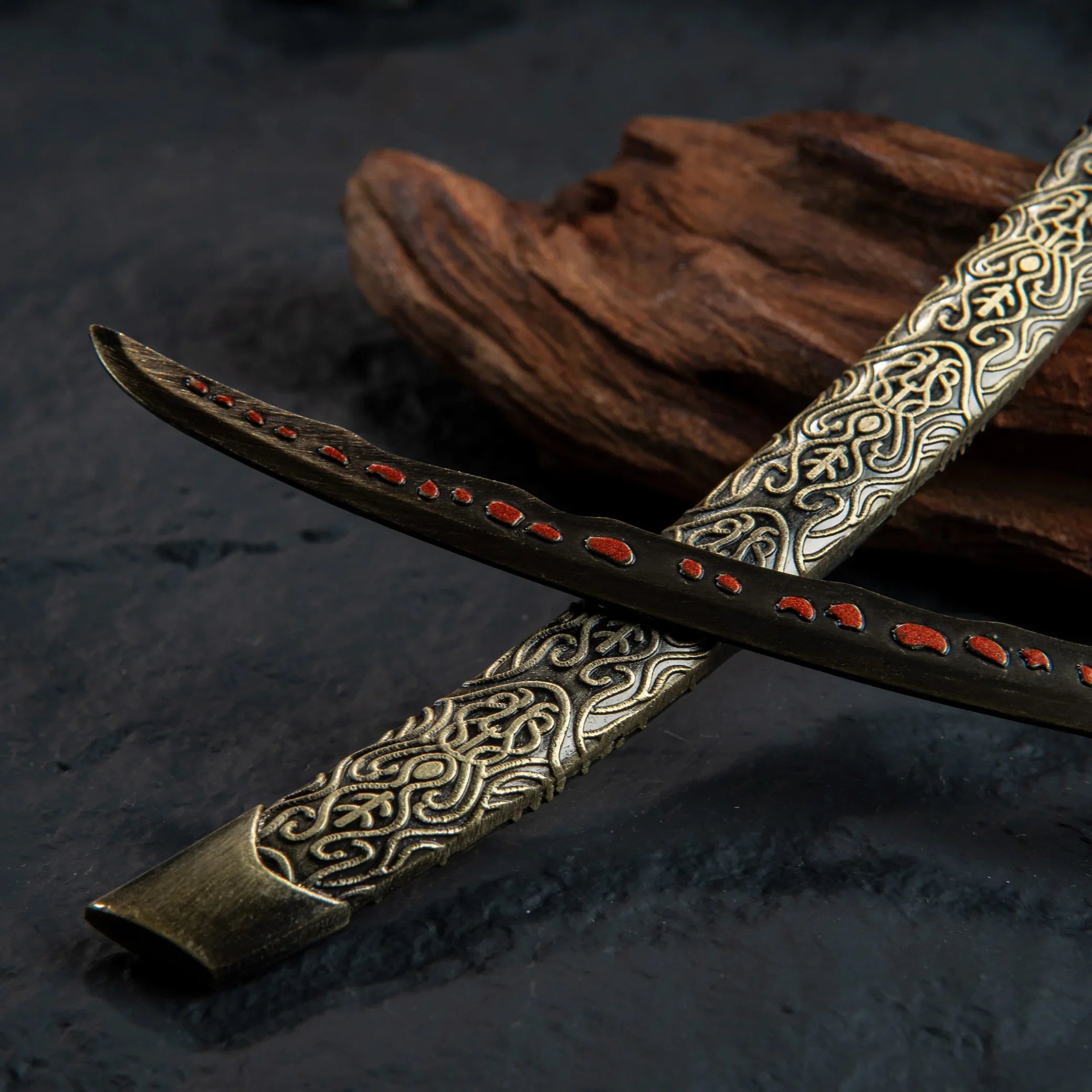 Macro shot of the black katana blade showing red meteoric ore spots and texture.