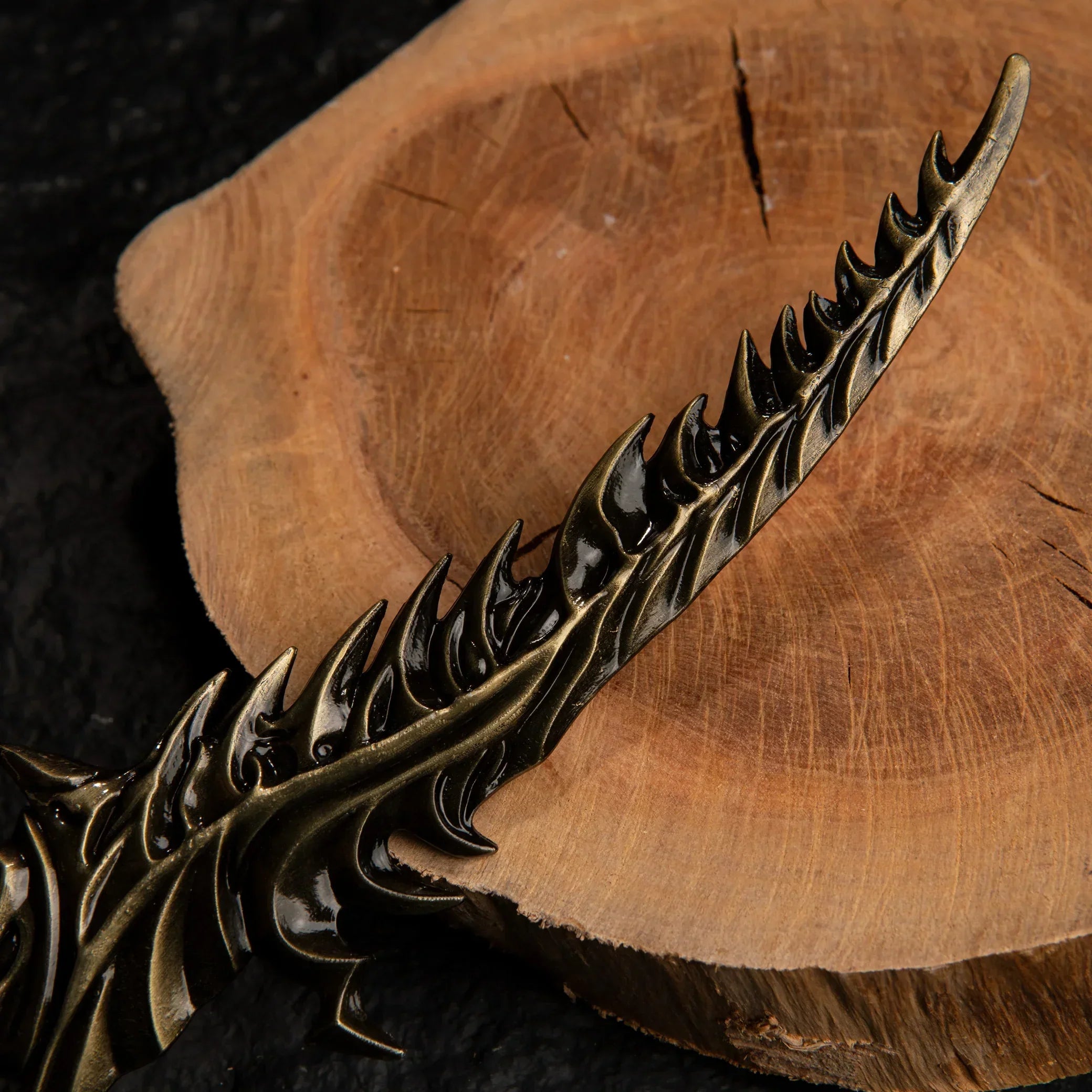 Macro shot of the Reduvia dagger replica blade, showing the sharp, teeth-like serrations along the edge.