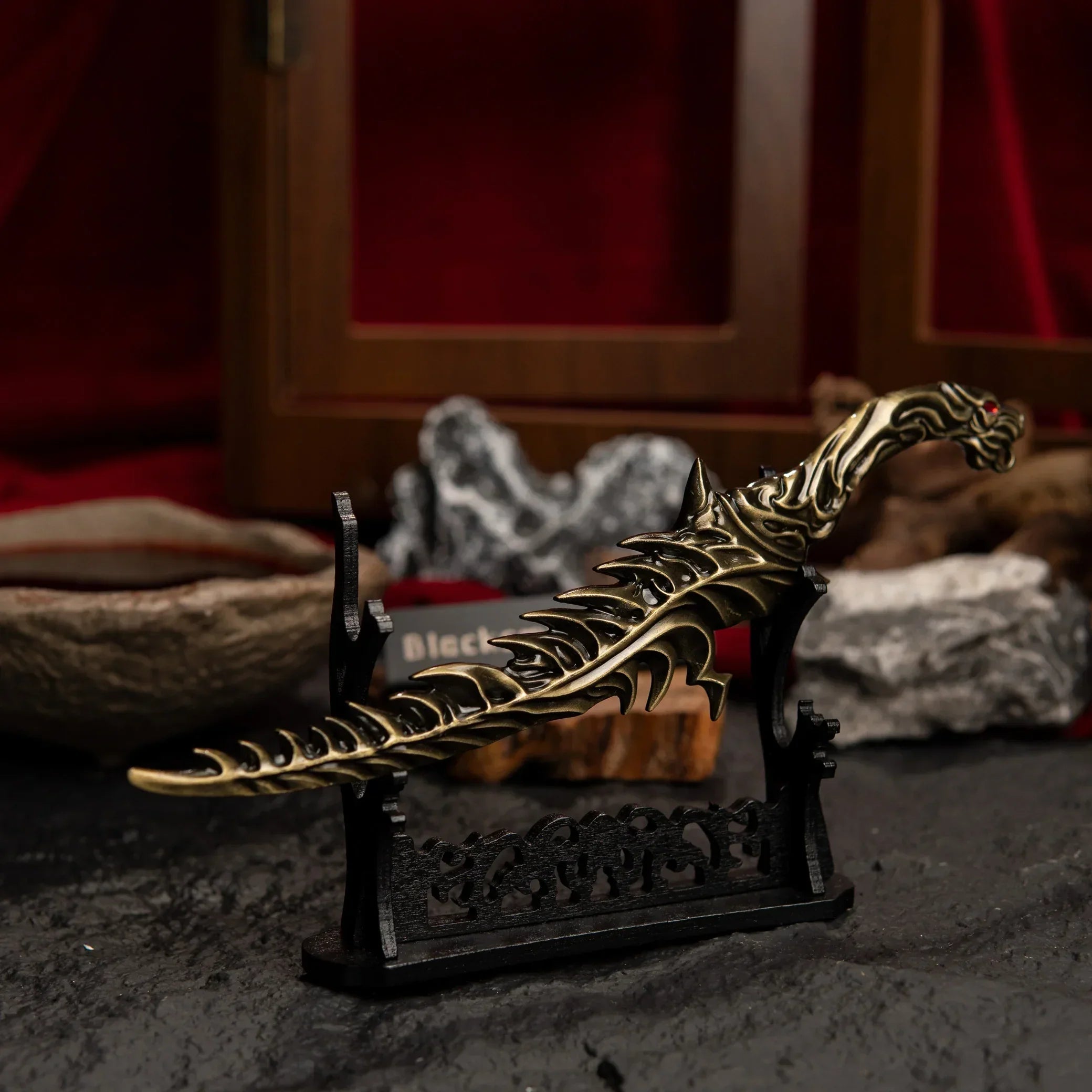 Reduvia dagger displayed horizontally on a large black sword stand with dragon carvings.
