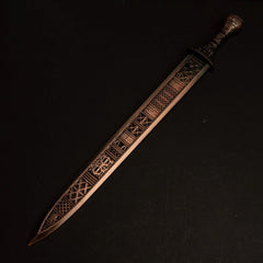 Regalia of Eochaid metal replica from Elden Ring isolated on a black background, showing its unique copper-colored blade.