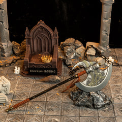 Axe of Godfrey replica (27.5cm die-cast zinc alloy axe) — resting on stone before a ruined throne, by BlacksmithSONG.