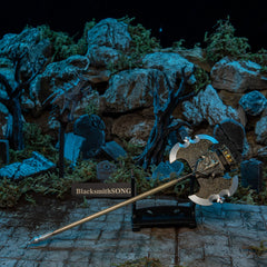 Axe of Godrick replica — angled on the small display stand in the graveyard set.