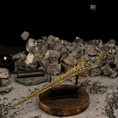 Dragon King's Cragblade displayed on a small horizontal stand in a dark, rocky setting.