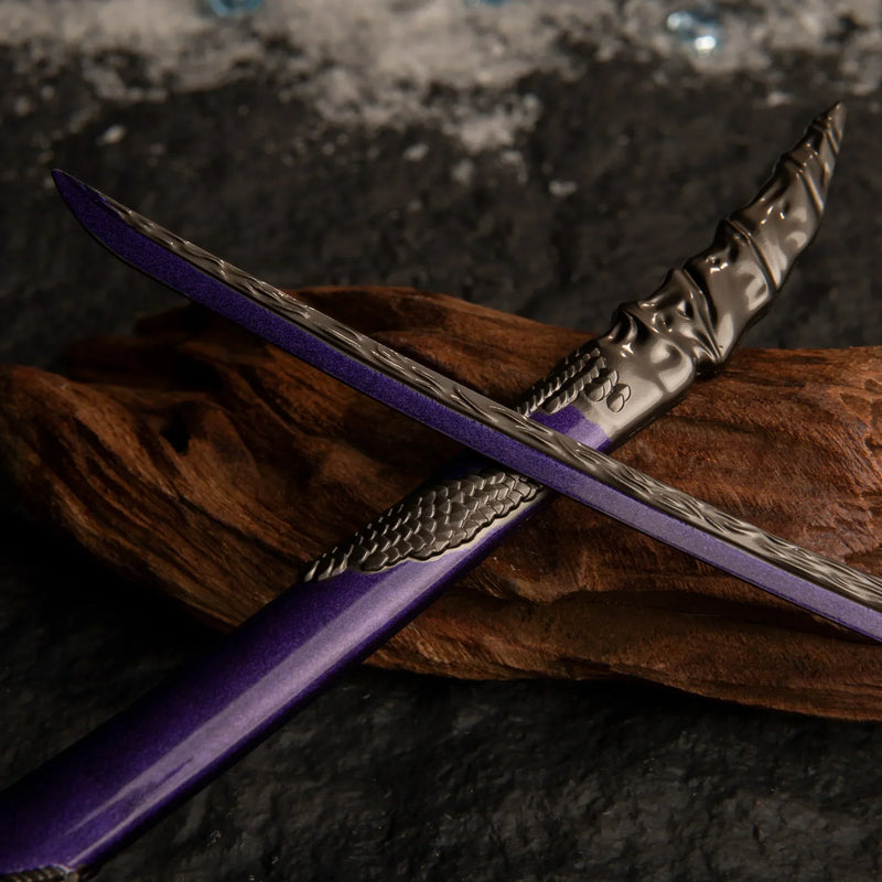 Macro shot of the Dragonscale Blade katana crossing over its scabbard on dark wood, highlighting the metallic texture and purple hue.