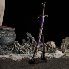 Vertical display of the Dragonscale Blade on an upright black stand against a dark snowy background.