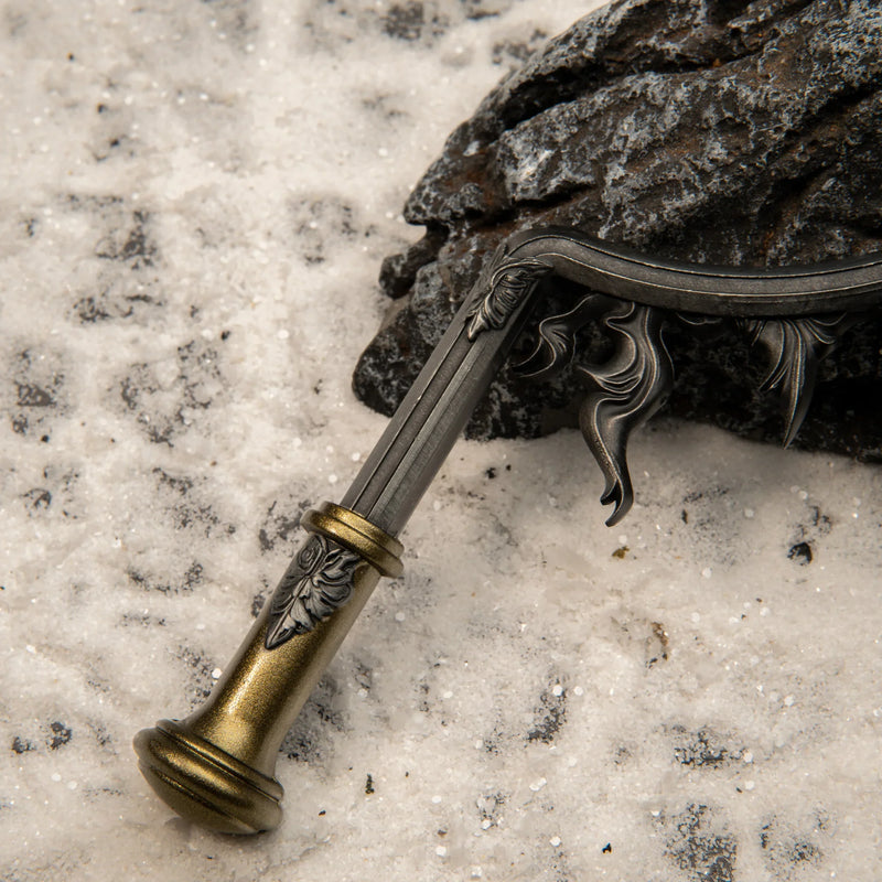 Eclipse Shotel replica — antique-gold grip and engraved blade base, close-up.
