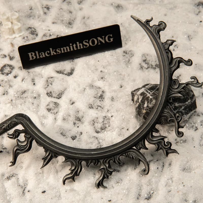 Eclipse Shotel replica — crescent blade with pierced flame filigree, close-up.
