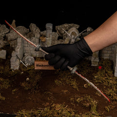 Hand clad in a black glove holding the 47.5cm Eleonora's Poleblade replica, showing its immense length compared to human scale.