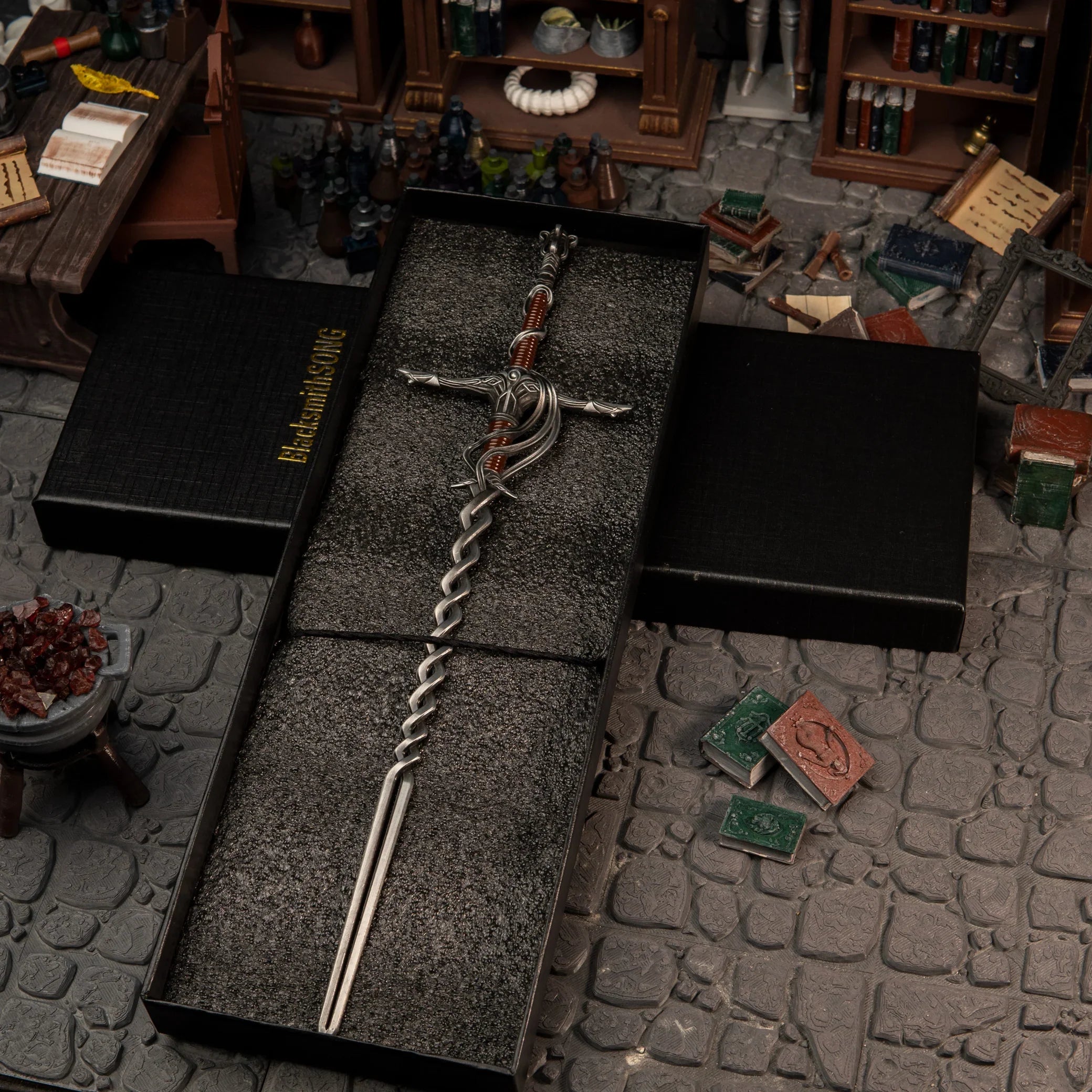 1/6 scale Fire Knight's Greatsword metal miniature inside a black gift box, placed in a Specimen Storehouse diorama.