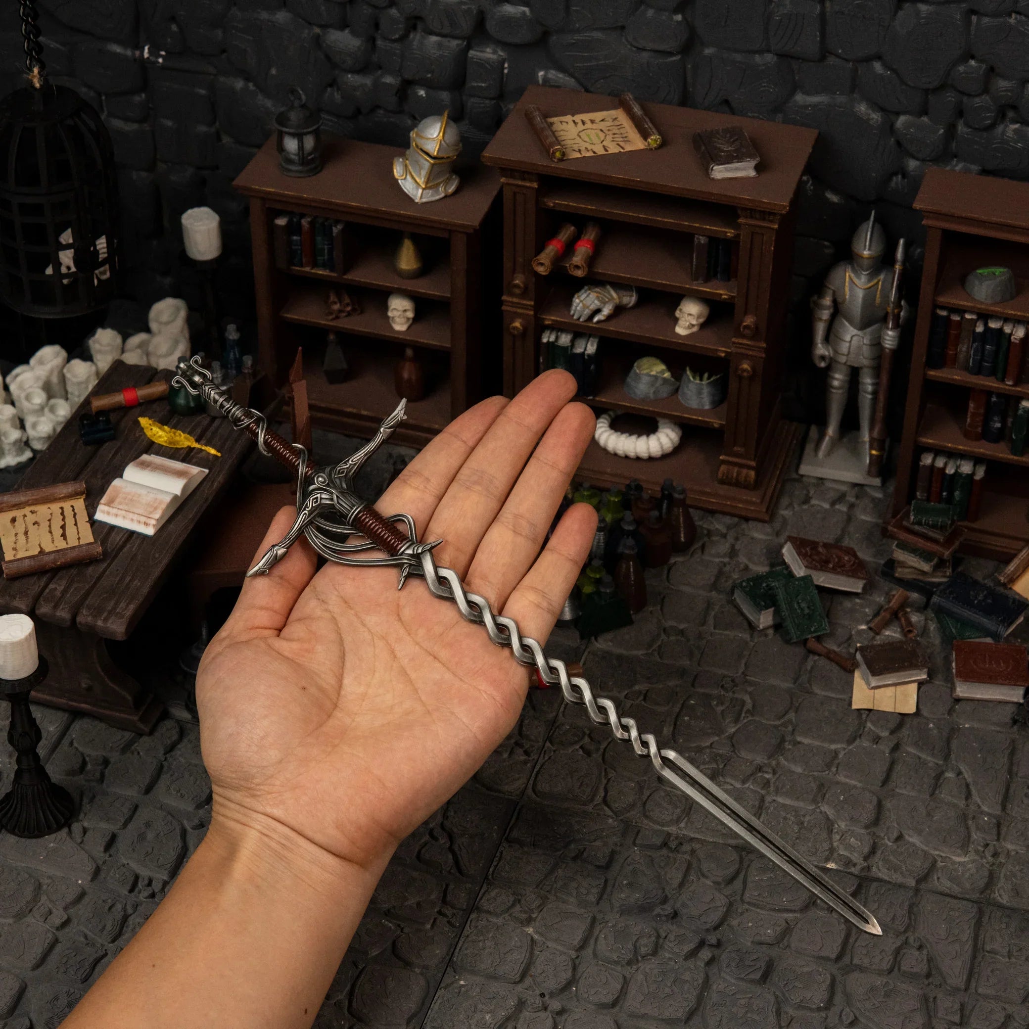 Human hand holding the 30cm Fire Knight's Greatsword replica, demonstrating its massive colossal sword length and 75g weight.