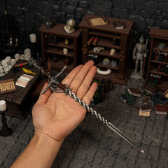 Human hand holding the 30cm Fire Knight's Greatsword replica, demonstrating its massive colossal sword length and 75g weight.