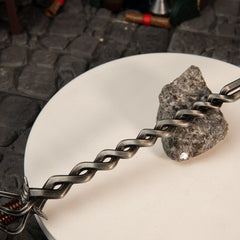 Detailed view of the wavy flamberge-style blade of the zinc alloy Fire Knight's Greatsword replica on cobblestones.