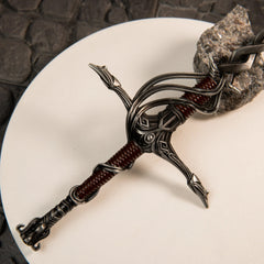 Close-up of the Fire Knight's Greatsword metal miniature's swept basket hilt guard, showing the intricate metal details.