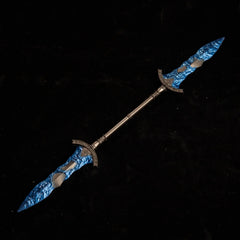 Gargoyle's Black Blades metal replica isolated on a black background, showcasing its twin blue crystal tips.
