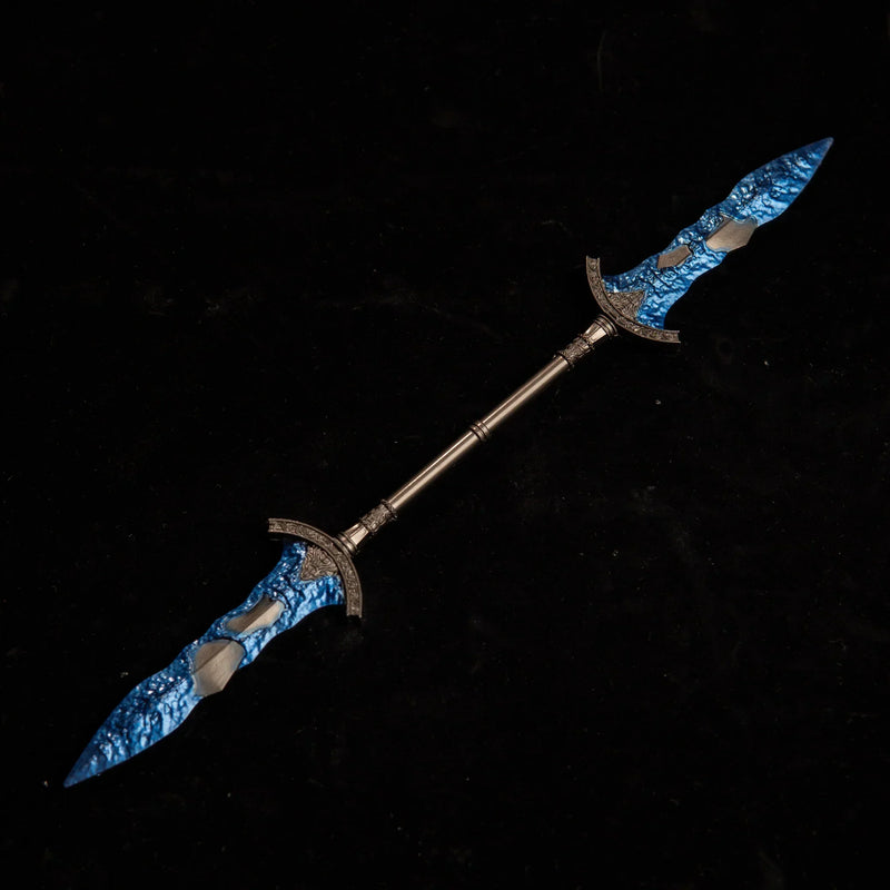 Gargoyle's Black Blades metal replica isolated on a black background, showcasing its twin blue crystal tips.