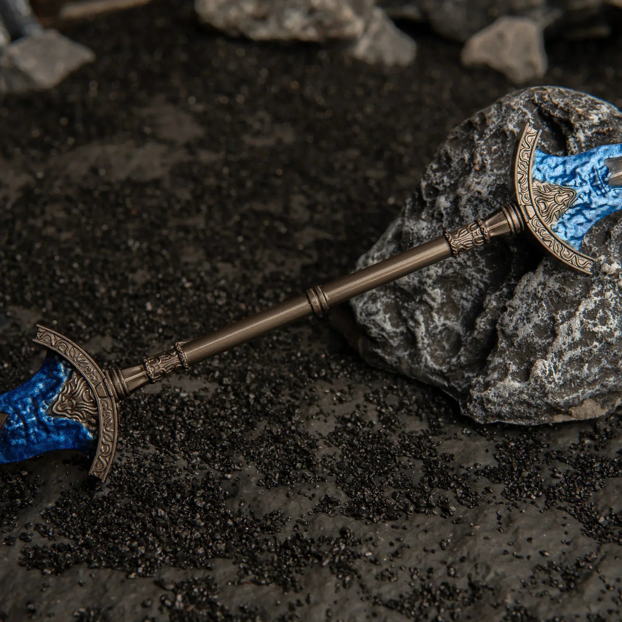 Macro detail of the central antique bronze hilt of the Gargoyle's Black Blades metal miniature.