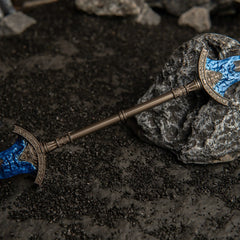 Macro detail of the central antique bronze hilt of the Gargoyle's Black Blades metal miniature.