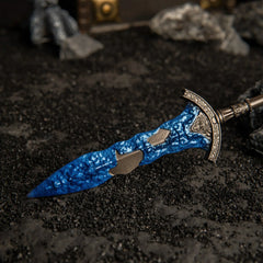 Close-up angled shot of the Gargoyle's Black Blades lying on black volcanic sand.