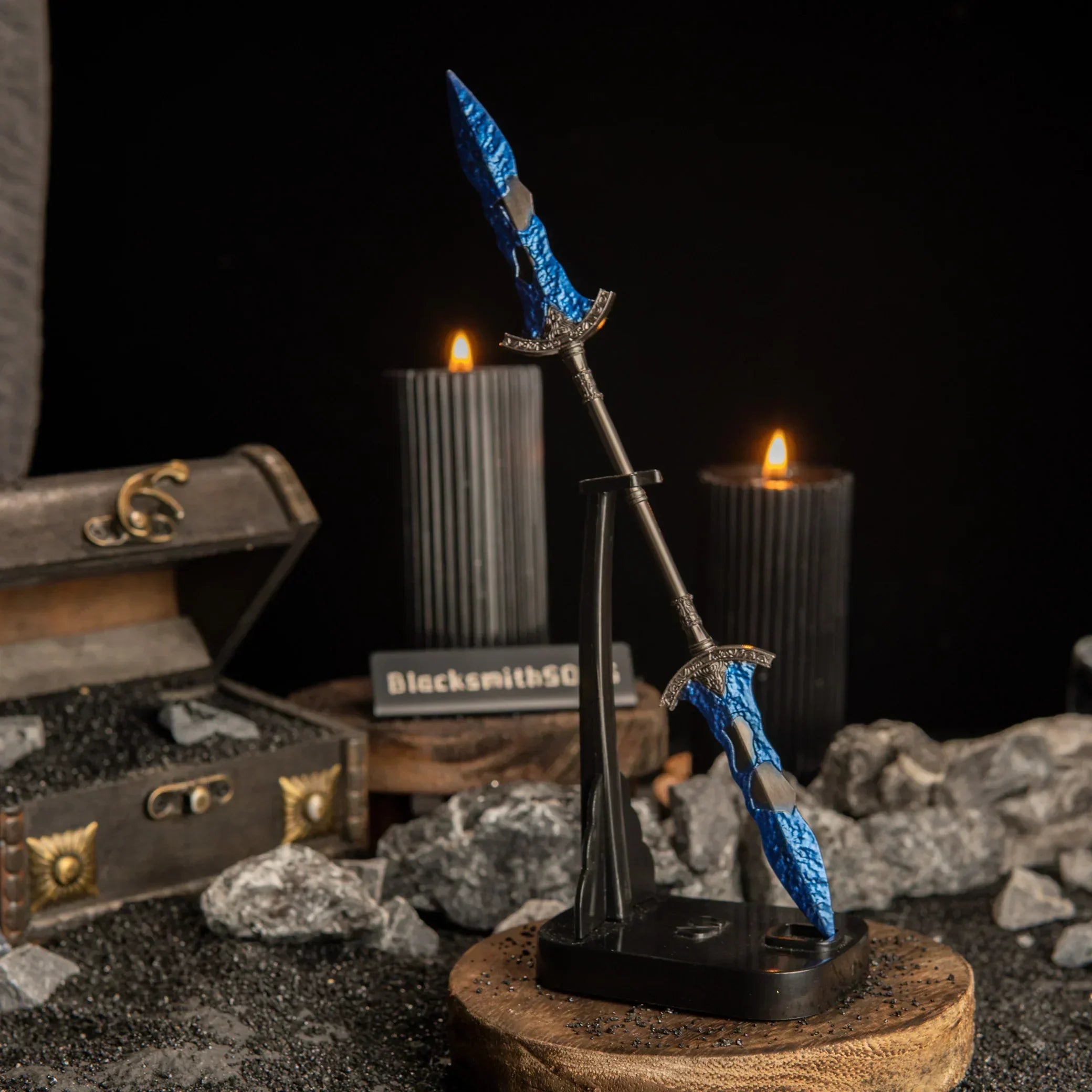 Vertical display of the Gargoyle's Black Blades on an upright black stand against a dark background with lit candles.
