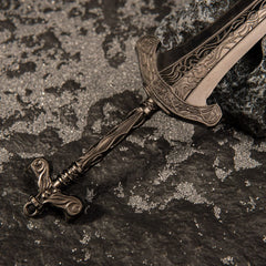 Macro close-up shot of the ornate bronze hilt and lower blade engravings of the Gargoyle's Greatsword metal miniature.