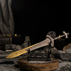 Close-up angled view of the Gargoyle's Greatsword on a small horizontal stand with lit black candles in the blurred background.