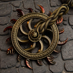 Ghiza's Wheel replica — serrated wheel face with braided rim and red-tipped teeth, close-up.