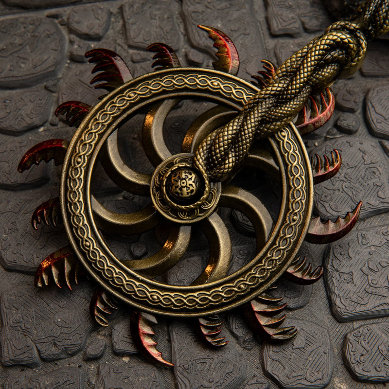 Ghiza's Wheel replica — serrated wheel face with braided rim and red-tipped teeth, close-up.