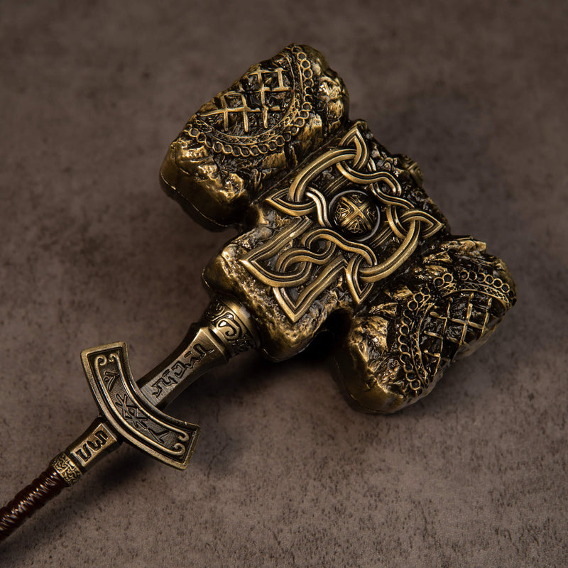 Giant-Crusher replica — close-up of the engraved crossguard, wrapped grip and T-shaped pommel.