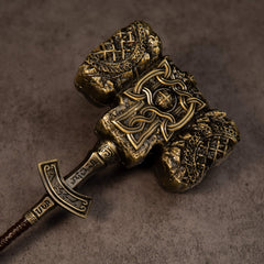 Giant-Crusher replica — close-up of the engraved crossguard, wrapped grip and T-shaped pommel.