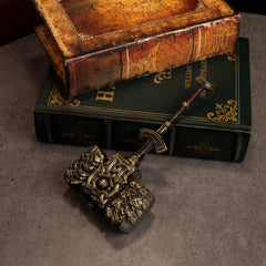 Giant-Crusher replica (17cm die-cast zinc alloy hammer) — antique-gold hammer on stacked books, by BlacksmithSONG.