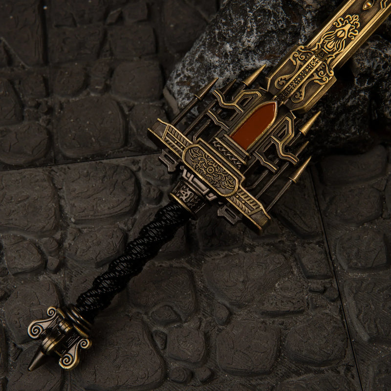Golden Epitaph replica — ornate openwork guard, inlaid panel and black cord-wrapped grip, close-up.