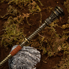 Golden Halberd replica — coiled shaft, red-brown grip and fluted pommel cap, close-up.