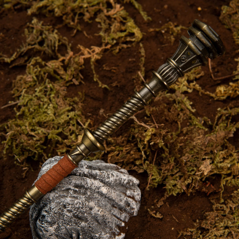 Golden Halberd replica — coiled shaft, red-brown grip and fluted pommel cap, close-up.