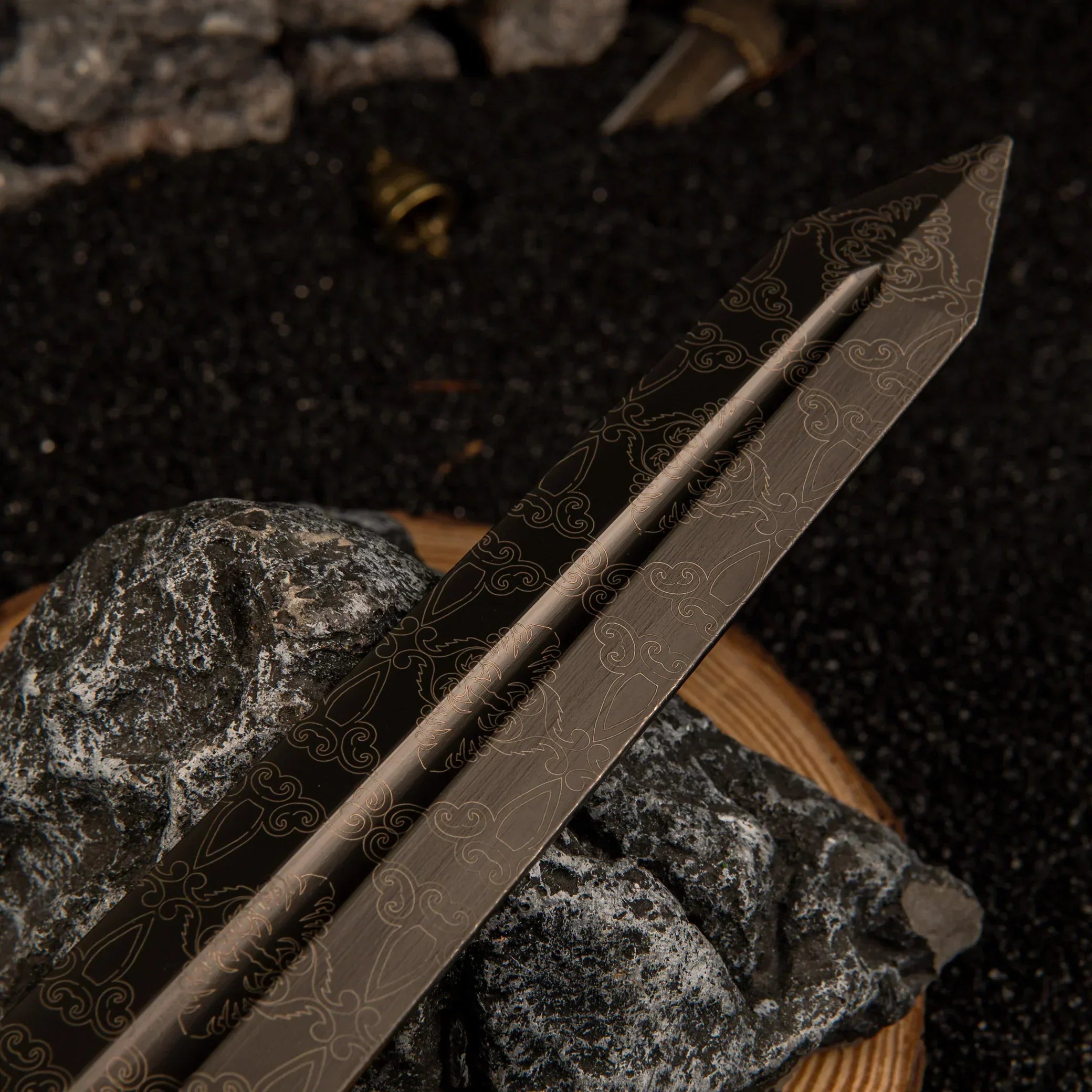 Detailed view of the wide, dark grey metallic blade of the Greatsword replica, showcasing subtle scrollwork engravings along the center fuller.