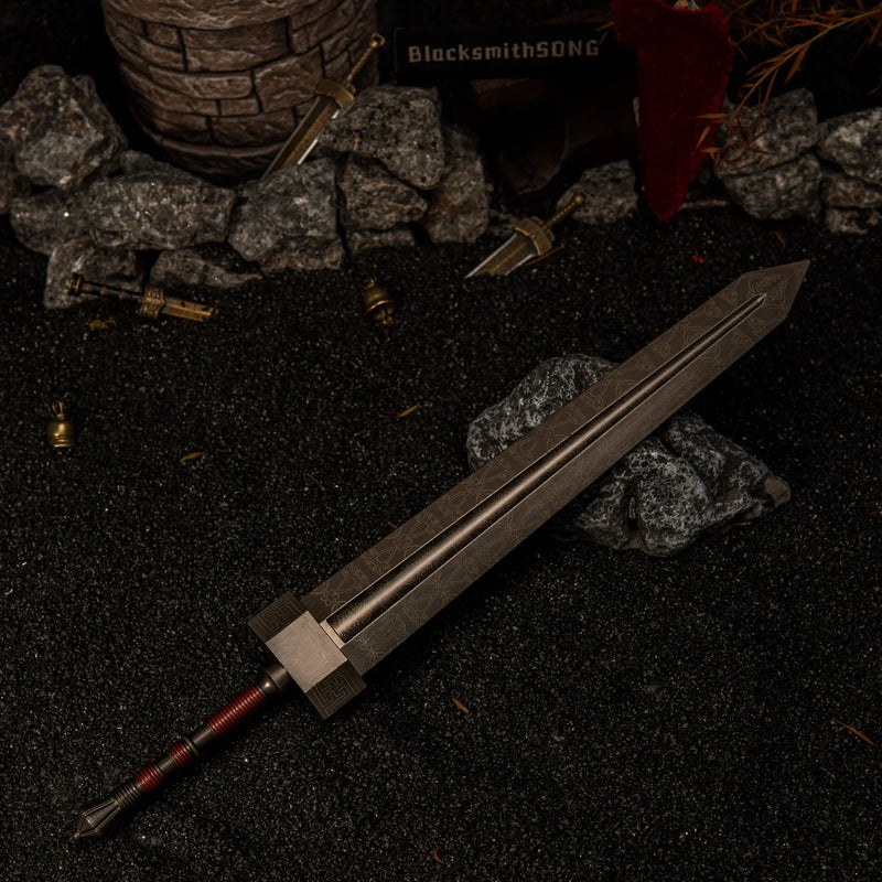 Wide angle view of the massive 30cm Greatsword metal miniature lying on dark rocks in a ruined battlefield setting with a stone tower in the background.