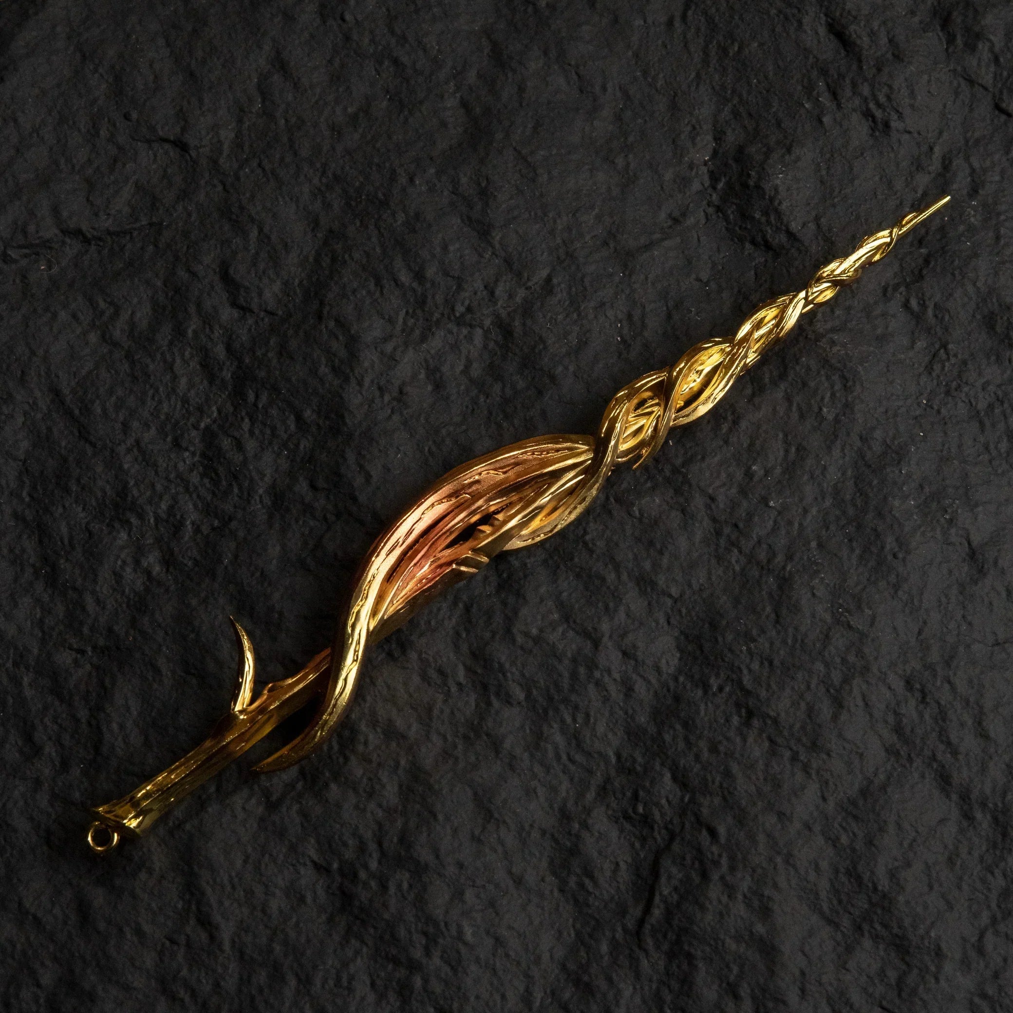 Greatsword of Damnation gold metal replica isolated on a black background, showing its twisted spiral design.