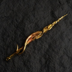 Greatsword of Damnation gold metal replica isolated on a black background, showing its twisted spiral design.
