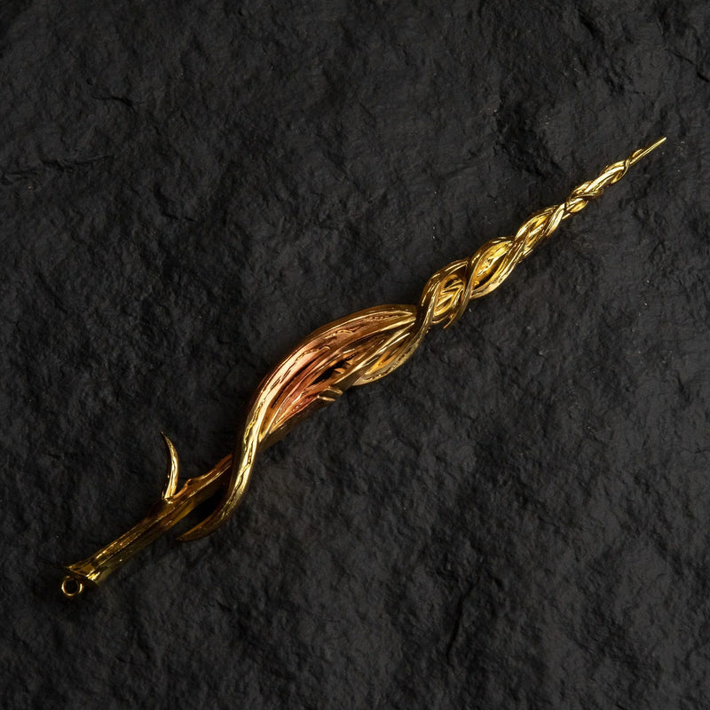 Greatsword of Damnation gold metal replica isolated on a black background, showing its twisted spiral design.