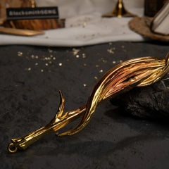 Close-up macro shot of the Greatsword of Damnation's handle, highlighting the twisted gold metal strands.