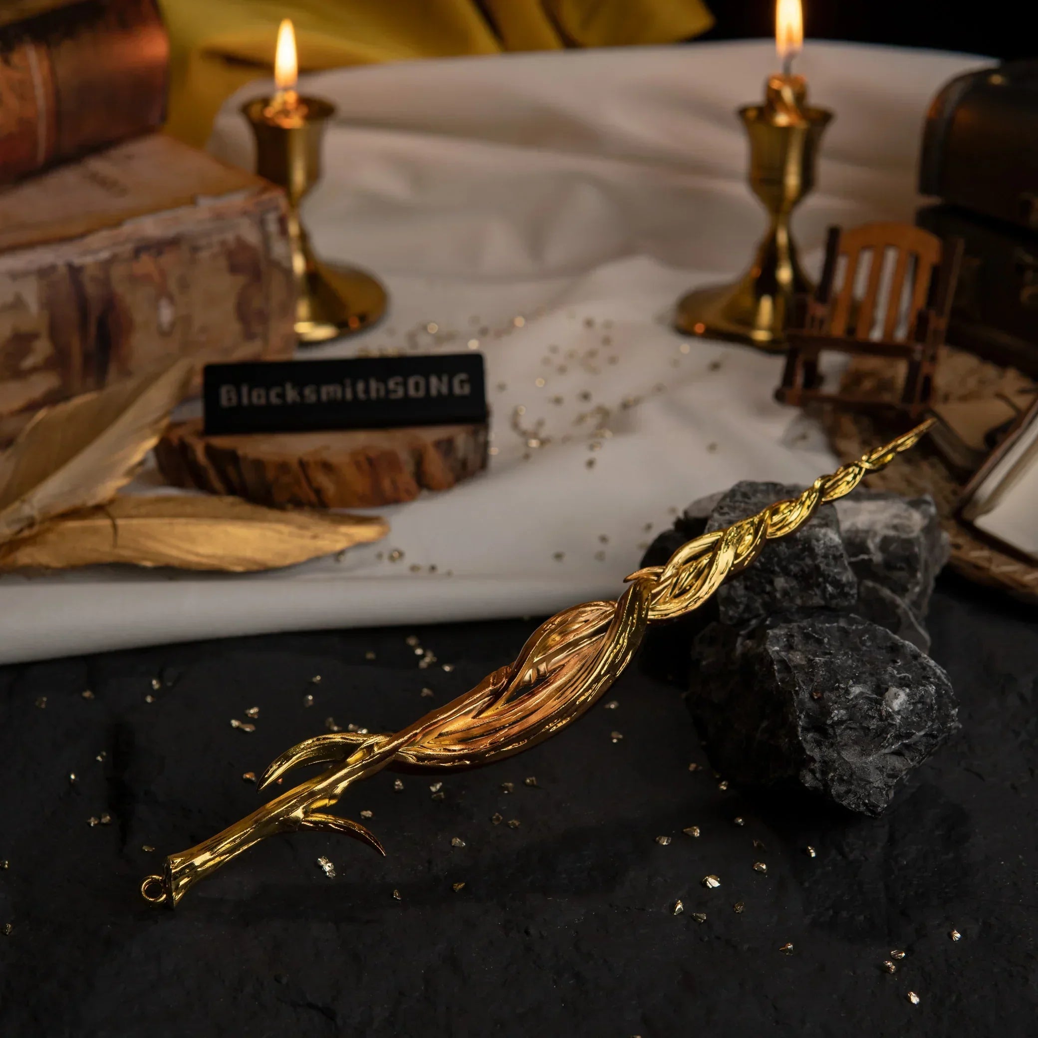 Greatsword of Damnation replica resting on dark rocks. The background features lit candles, vintage books, and gold feathers.